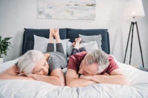 Senior wife and husband sleeping in bed together at homeWhy Do Older Adults Sleep Less | Wenatex