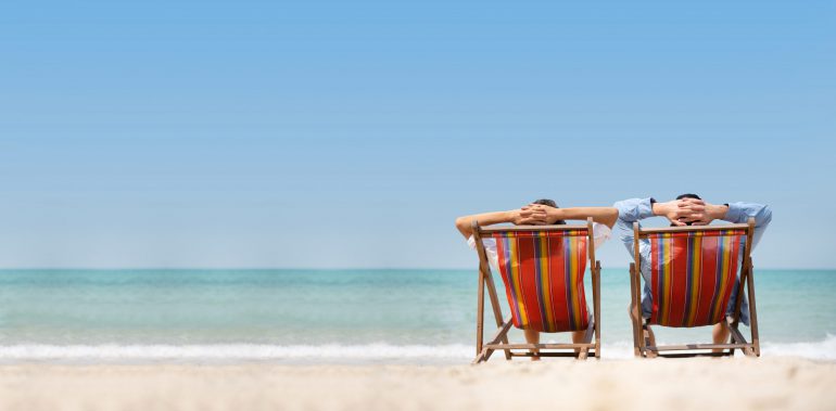 Couple relaxing on beach chairs | Featured image for Feeling that holiday fatigue?