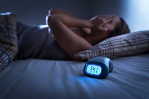 Sleepless woman suffering from insomnia | Featured image for Are worry and anxious thoughts keeping you awake at night?