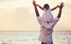 Father with their child on their shoulder | Featured Image for Sleeping On A Cloud With Silver Lining blog on Wenatex.