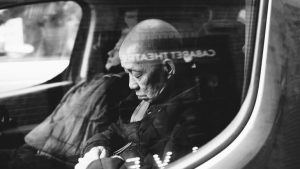 Black and white photo of people sleeping in a vehicle | Featured image for Seniors Need Just As Much Sleep As Younger People.