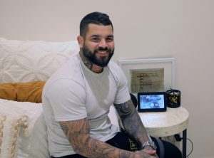 Photo of Adam Reynolds sitting on his Wenatex mattress | Featured Image for Conversation with Adam Reynolds Blog by Wenatex.
