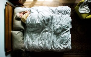 Elderly Caucasian Woman Sleeping on Her Bed | Featured image for Wenatex’s Sleep Positions Blog.