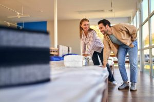 Young couple shopping for a mattress | Featured image for Wenatex’s Benefits of a Good Mattress Blog.