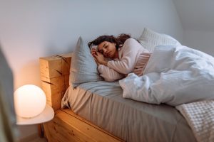 Woman getting green sleep on eco friendly bedding products | Featured image for Wenatex’s Eco Sleep Blog.